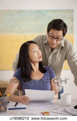 Couple doing paperwork View Large Photo Image Stock Image - Couple doing paperwork. Fotosearch