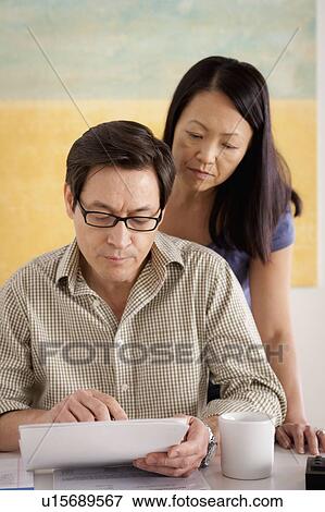 Stock Photo - Couple doing paperwork. Fotosearch