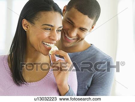 Couple eating potato chips View Large Photo Image Stock Image - Couple eating potato chips. Fotosearch