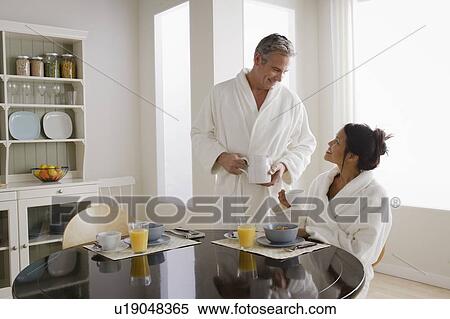 Couple having breakfast in kitchen View Large Photo Image Stock Photography - Couple having breakfast in kitchen. Fotosearch