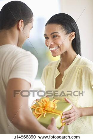 Couple holding gift box View Large Photo Image Stock Image - Couple holding gift box. Fotosearch