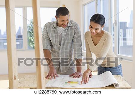 Couple looking at house blueprints View Large Photo Image Stock Image - Couple looking at house blueprints. Fotosearch