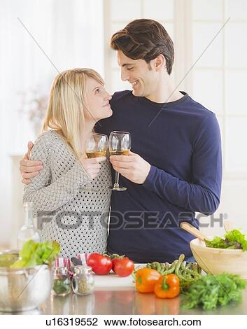 Couple preparing food in kitchen and making toast View Large Photo Image Stock Image - Couple preparing food in kitchen and making toast. Fotosearch