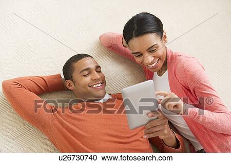 Couple reading e-book View Large Photo Image Stock Image - Couple reading e-book. Fotosearch