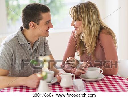 Stock Photo - Couple sitting at table. Fotosearch