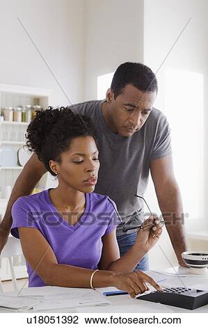 Couple using calculator View Large Photo Image Stock Image - Couple using calculator. Fotosearch