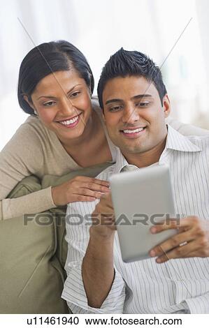 Stock Image - Couple using digital tablet. Fotosearch