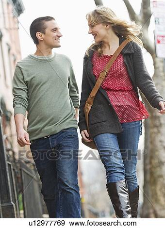 Couple walking on street View Large Photo Image Stock Photo - Couple walking on street. Fotosearch