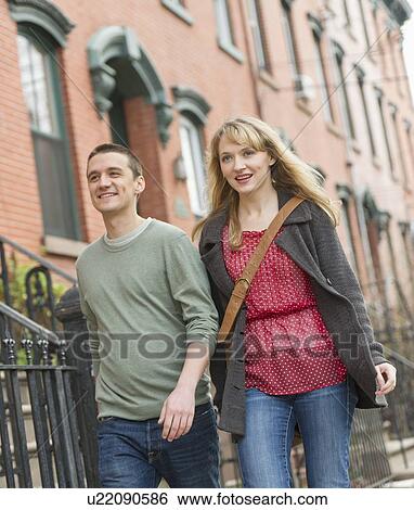 Couple walking on street View Large Photo Image Stock Photograph - Couple walking on street. Fotosearch