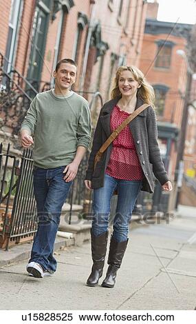 Stock Photography - Couple walking on street. Fotosearch