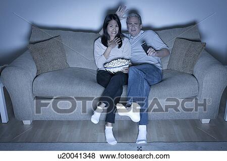 Couple watching television View Large Photo Image Stock Photo - Couple watching television. Fotosearch