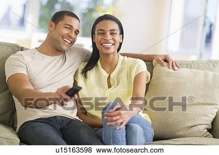 Couple watching tv at home View Large Photo Image Stock Photo - Couple watching tv at home. Fotosearch