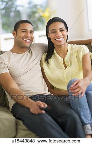 Couple watching tv at home View Large Photo Image Stock Photo - Couple watching tv at home. Fotosearch