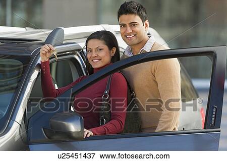 Couple with new car View Large Photo Image Stock Photo - Couple with new car. Fotosearch