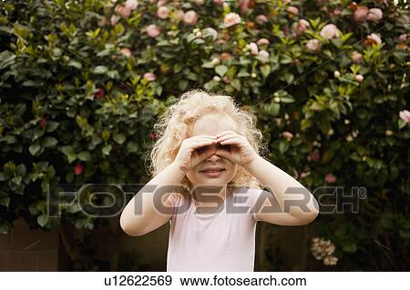 Cute blonde girl (4-5) looking through imaginary binoculars View Large Photo Image Stock Photo - Cute blonde girl (4-5) looking through imaginary binoculars. Fotosearch