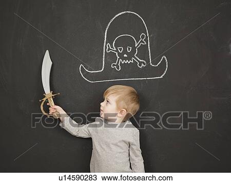 Cute toddler boy (2-3) standing against blackboard posing as pirate View Large Photo Image Stock Image - Cute toddler boy (2-3) standing against blackboard posing as pirate. Fotosearch