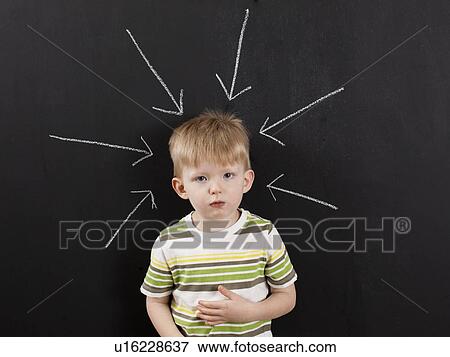 Cute toddler boy (2-3) standing against blackboard with arrows written in chalk pointing at him View Large Photo Image Stock Photo - Cute toddler boy (2-3) standing against blackboard with arrows written in chalk pointing at him. Fotosearch