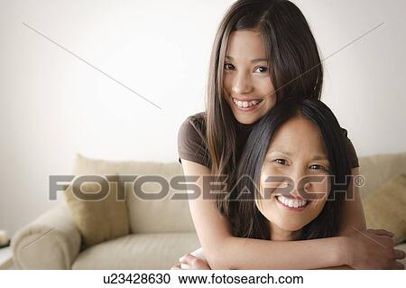 Stock Image - Daughter embracing mother. Fotosearch