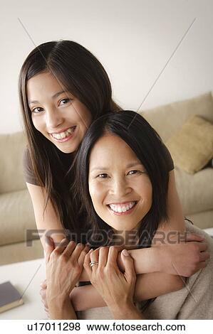 Stock Photo - Daughter embracing mother. Fotosearch
