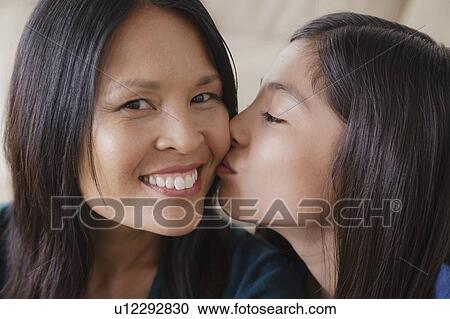 Daughter giving mother kiss on cheek View Large Photo Image Stock Image - Daughter giving mother kiss on cheek. Fotosearch