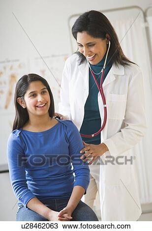 Doctor examining girl (12-13) View Large Photo Image Stock Image - Doctor examining girl (12-13). Fotosearch