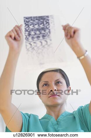 Doctor examining medical record View Large Photo Image Stock Image - Doctor examining medical record. Fotosearch