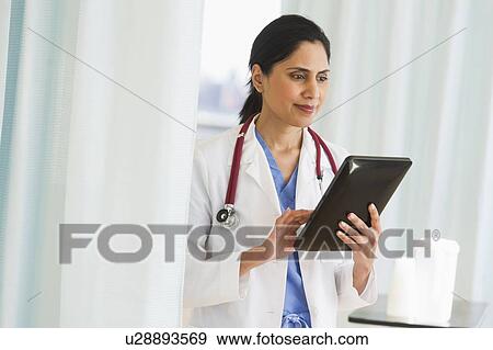 Doctor working on digital tablet View Large Photo Image Stock Photo - Doctor working on digital tablet. Fotosearch