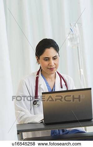 Doctor working on laptop View Large Photo Image Stock Photo - Doctor working on laptop. Fotosearch