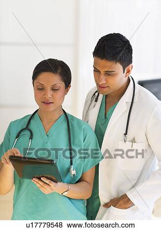 Doctors using digital tablet View Large Photo Image Stock Photo - Doctors using digital tablet. Fotosearch