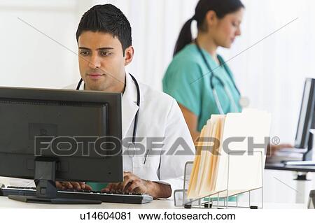 Stock Image - Doctors working on computers. Fotosearch
