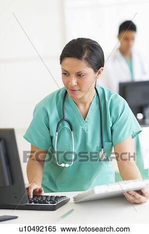 Doctors working on computers View Large Photo Image Stock Photography - Doctors working on computers. Fotosearch