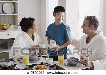 Stock Photograph - Family having breakfast. Fotosearch