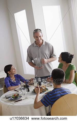 Picture - Family having breakfast together. Fotosearch