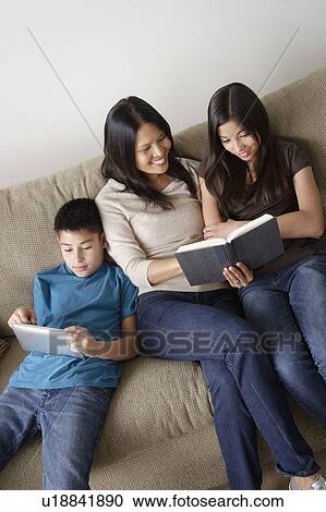 Family reading together View Large Photo Image Stock Image - Family reading together. Fotosearch