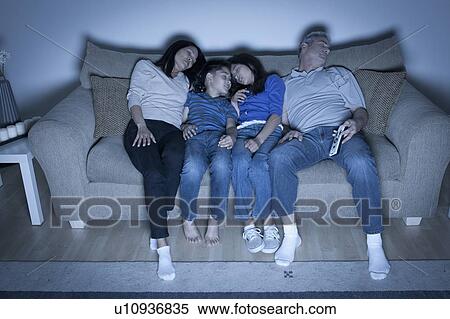 Stock Photography - Family sitting on sofa sleeping. Fotosearch