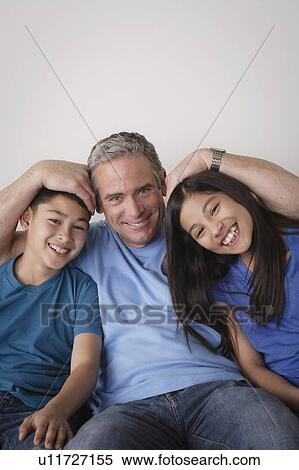 Stock Photography - Father and offspring messing about. Fotosearch