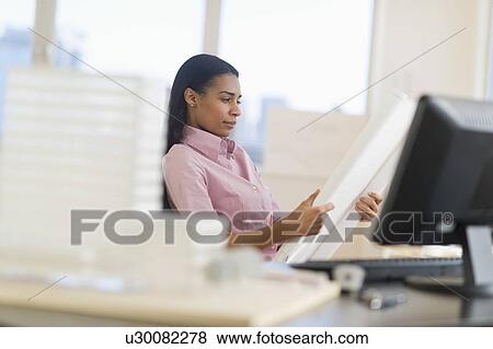 Stock Photo - Female architect in office. Fotosearch
