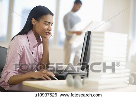 Stock Photograph - Female architect in office. Fotosearch