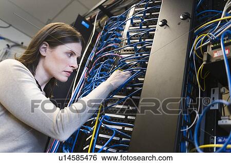 Female IT support technician repairing server View Large Photo Image Stock Photograph - Female IT support technician repairing server. Fotosearch