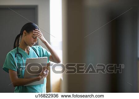 Female nurse with head in hands View Large Photo Image Stock Photograph - Female nurse with head in hands. Fotosearch