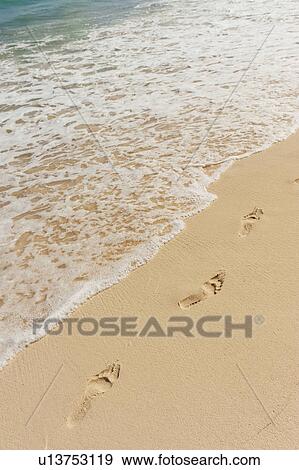 Stock Photo - Footprints on beach. Fotosearch