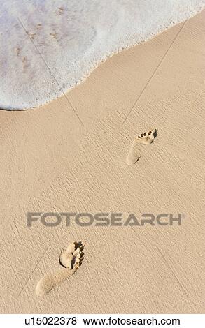 Stock Photo - Footprints on beach. Fotosearch