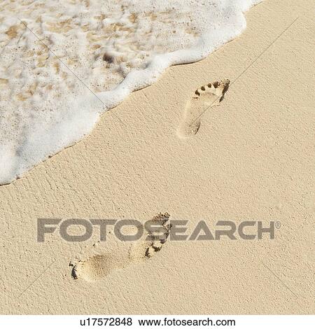 Stock Photo - Footprints on beach. Fotosearch