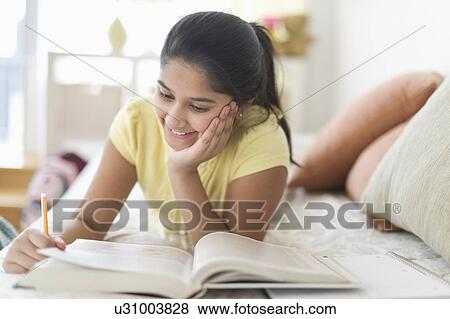 Girl (12-13) Girl reading book View Large Photo Image Stock Photo - Girl (12-13) Girl reading book. Fotosearch
