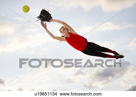 Girl (12-13) plying softball View Large Photo Image Picture - Girl (12-13) plying softball. Fotosearch