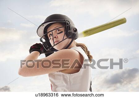 Stock Photograph - Girl (12-13) plying softball. Fotosearch