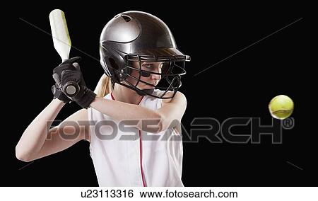 Stock Photograph - Girl (12-13) plying softball, studio shot. Fotosearch