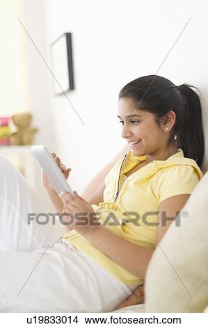 Girl (12-13) using digital tablet View Large Photo Image Picture - Girl (12-13) using digital tablet. Fotosearch