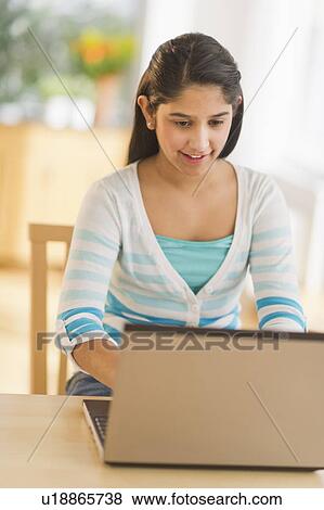 Girl (12-13) using laptop View Large Photo Image Stock Photo - Girl (12-13) using laptop. Fotosearch