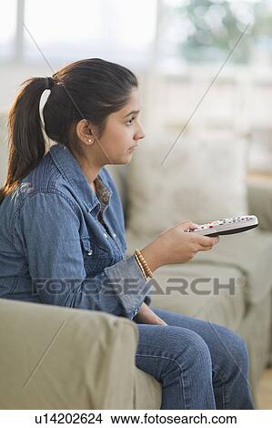 Girl (12-13) watching tv View Large Photo Image Picture - Girl (12-13) watching tv. Fotosearch